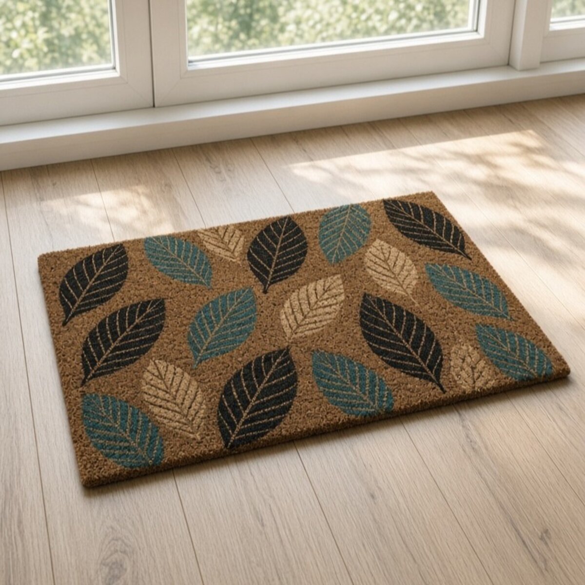 Printed coir mat with leaf pattern in teal and black